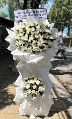 White floral arrangement with sign